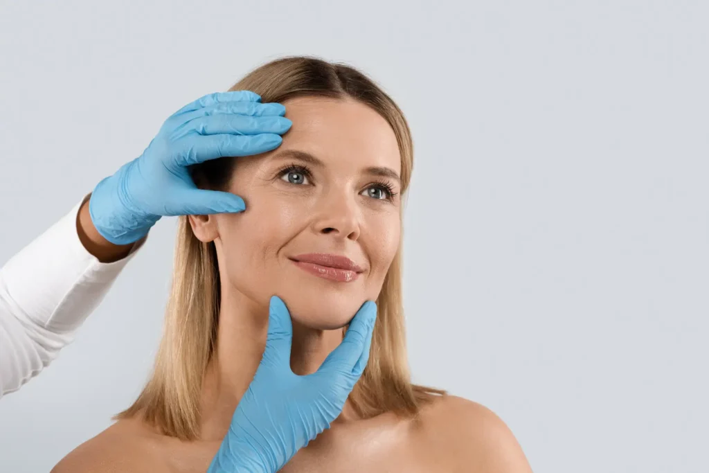 Doctor examining woman's face during cosmetic consultation