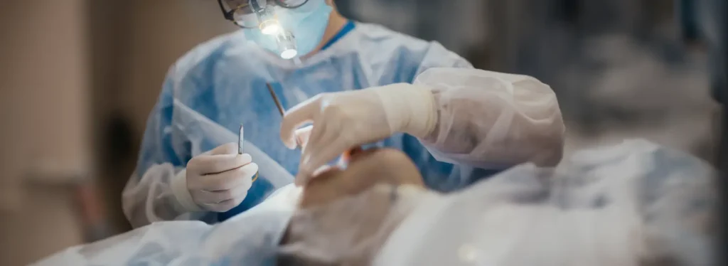Close-up of surgeon hands using tools during procedure
