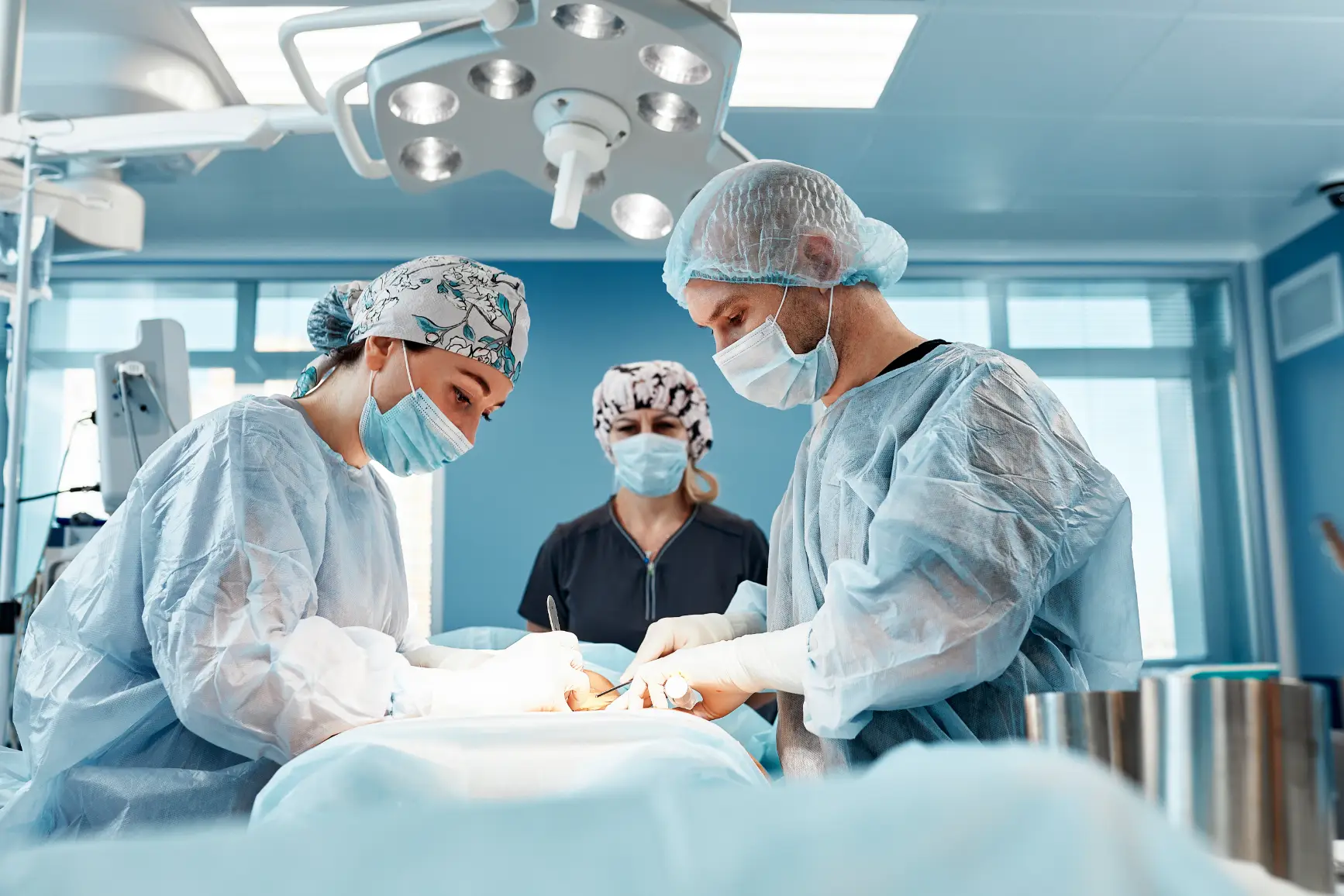 Surgical team performing procedure in operating room with masks